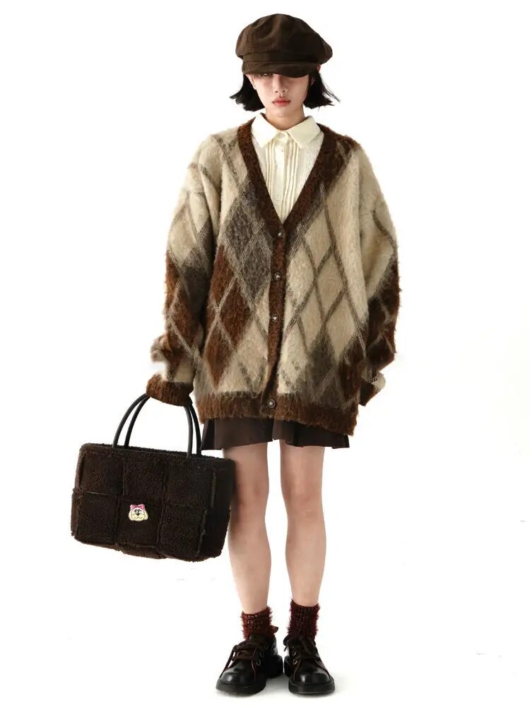 Full-length styling view of the brown and cream argyle cardigan over a cream shirt and brown skirt. Cardigan only.