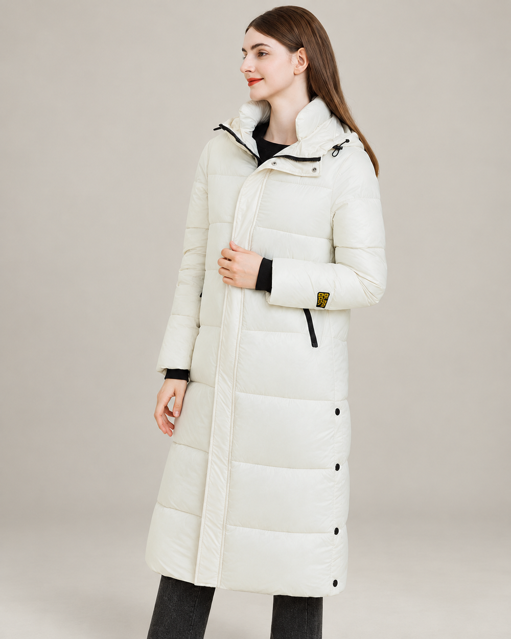 Studio presentation of white longline hooded puffer coat